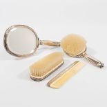 A collection of silver-plated vanity items.