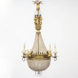 A bronze 'Sac-ˆ-Perles' chandelier in empire style with ormolu gold swans and putti, the first half