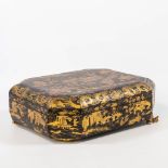 A Chinese lacquered storage box, with gold decor, on sculpured wood feet. (37 x 29 x 13 cm)