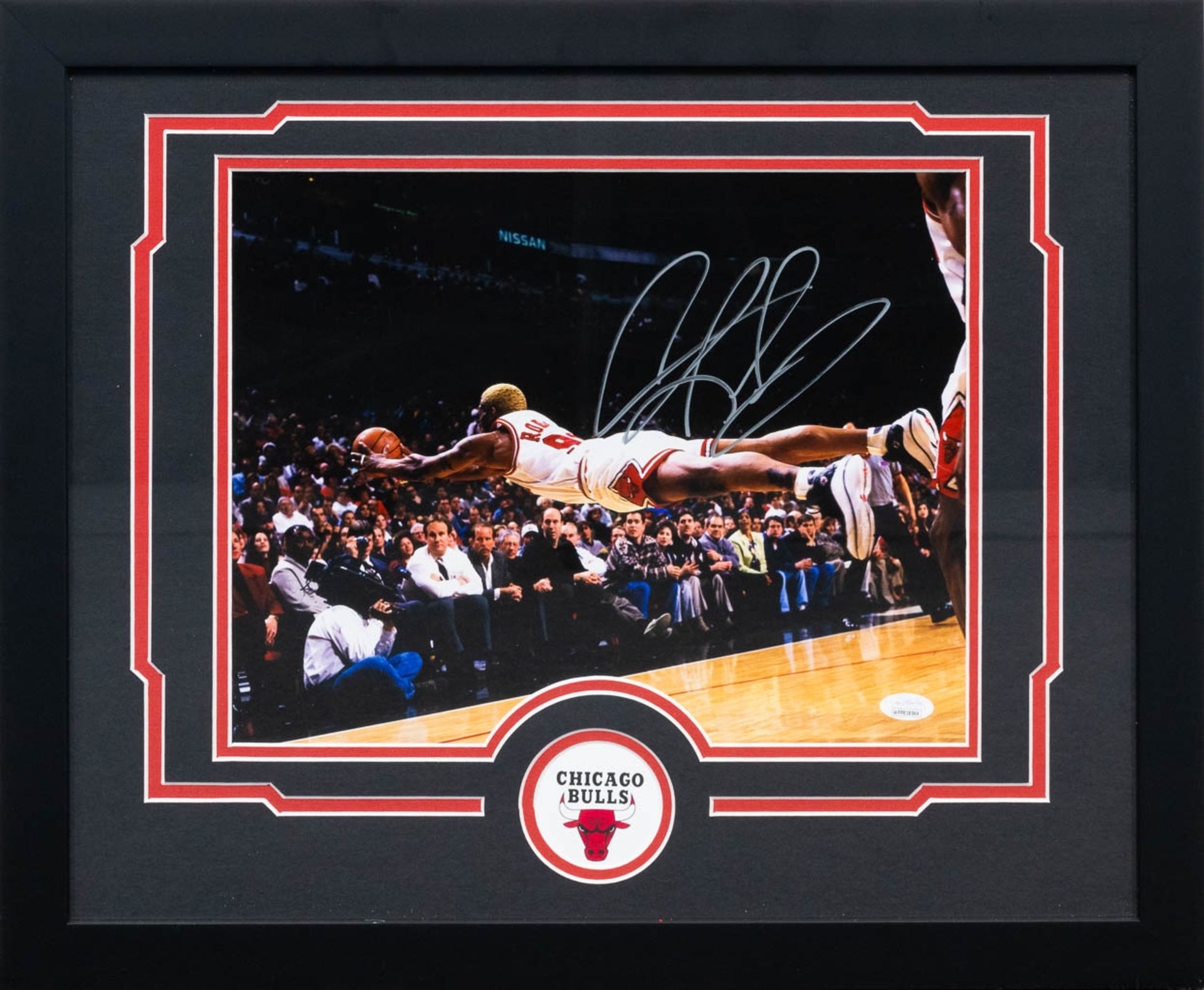 A photograph of Dennis Rodman, a Basketball player with The Chicago Bulls, with an autograph signatu