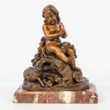 A bronze statue of a boy sitting on a rock sided by a lamb. Not marked. (9,5 x 18 x 23 cm)