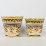 A collection of 2 cache-pots in two sizes with hand-painted decor, made of faience in Rouen, France.