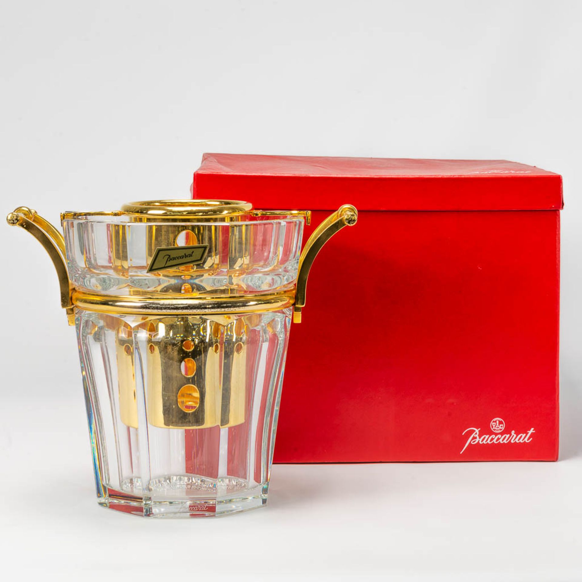 A Baccarat wine cooler or Champage bucket, made of Crystal with gold plated metal in the original bo