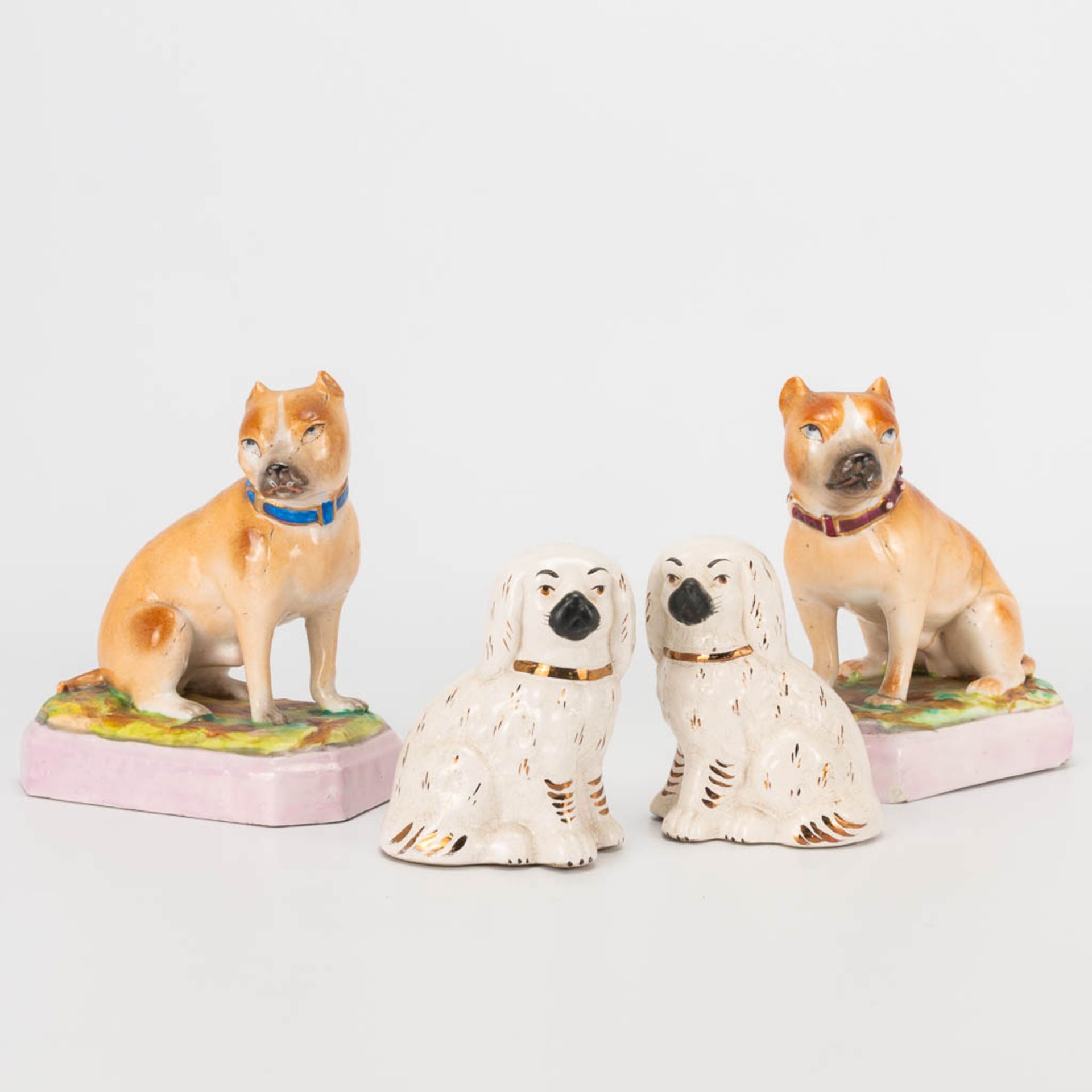A collection of 2 pairs of porcelain dogs, marked L&M and Staffordshire. The second half of the 19th