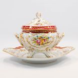 A large porcelain Tureen made with hand-painted flower decor and with a lid on a plate. Marked JD Li