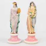 A pair of bisque porcelain statues of 2 ladies with garlands, probably Italy, second half of the 19t