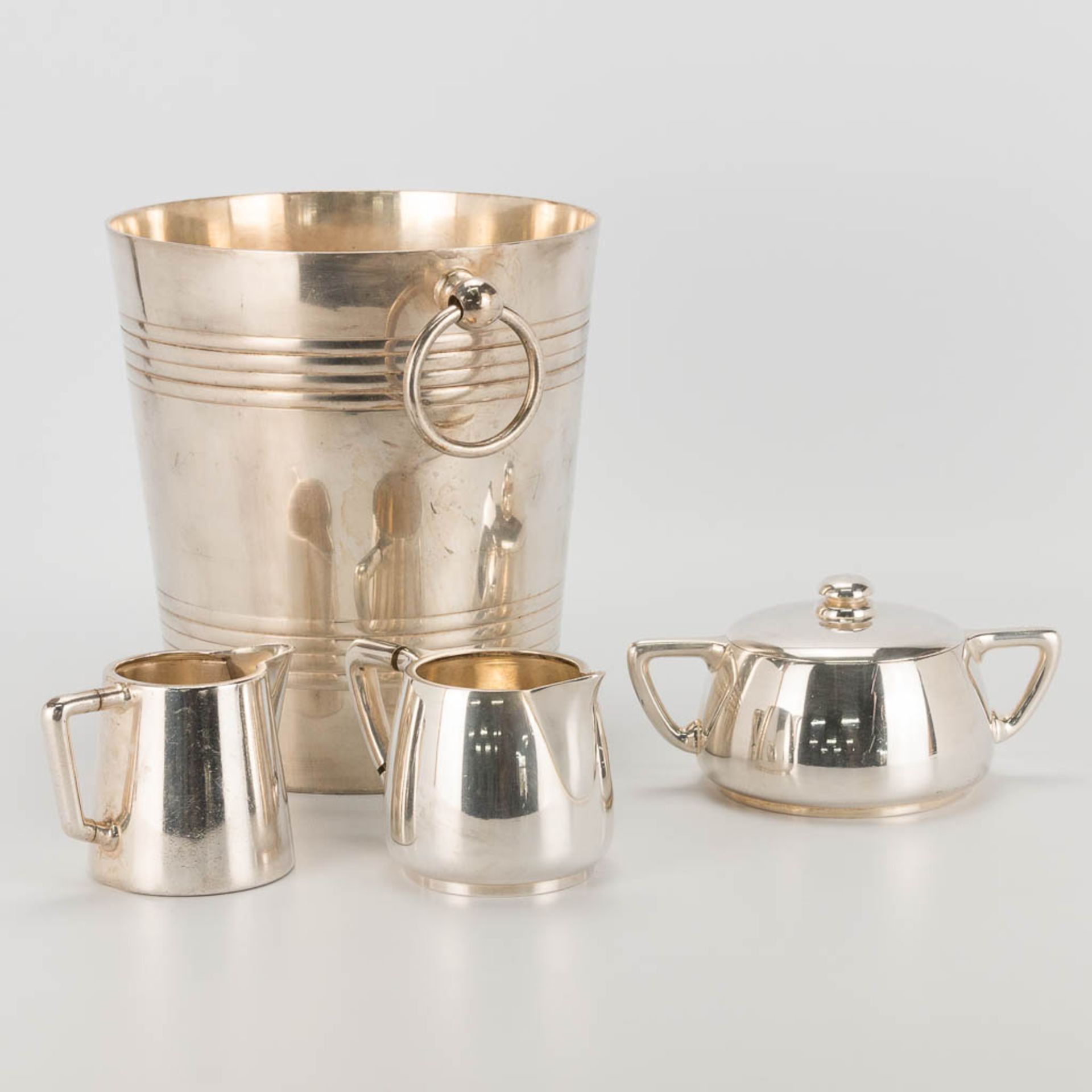 A collection of 4 silver-plated items a champagne bucket, teapot, sugar pot and milk jug made by and