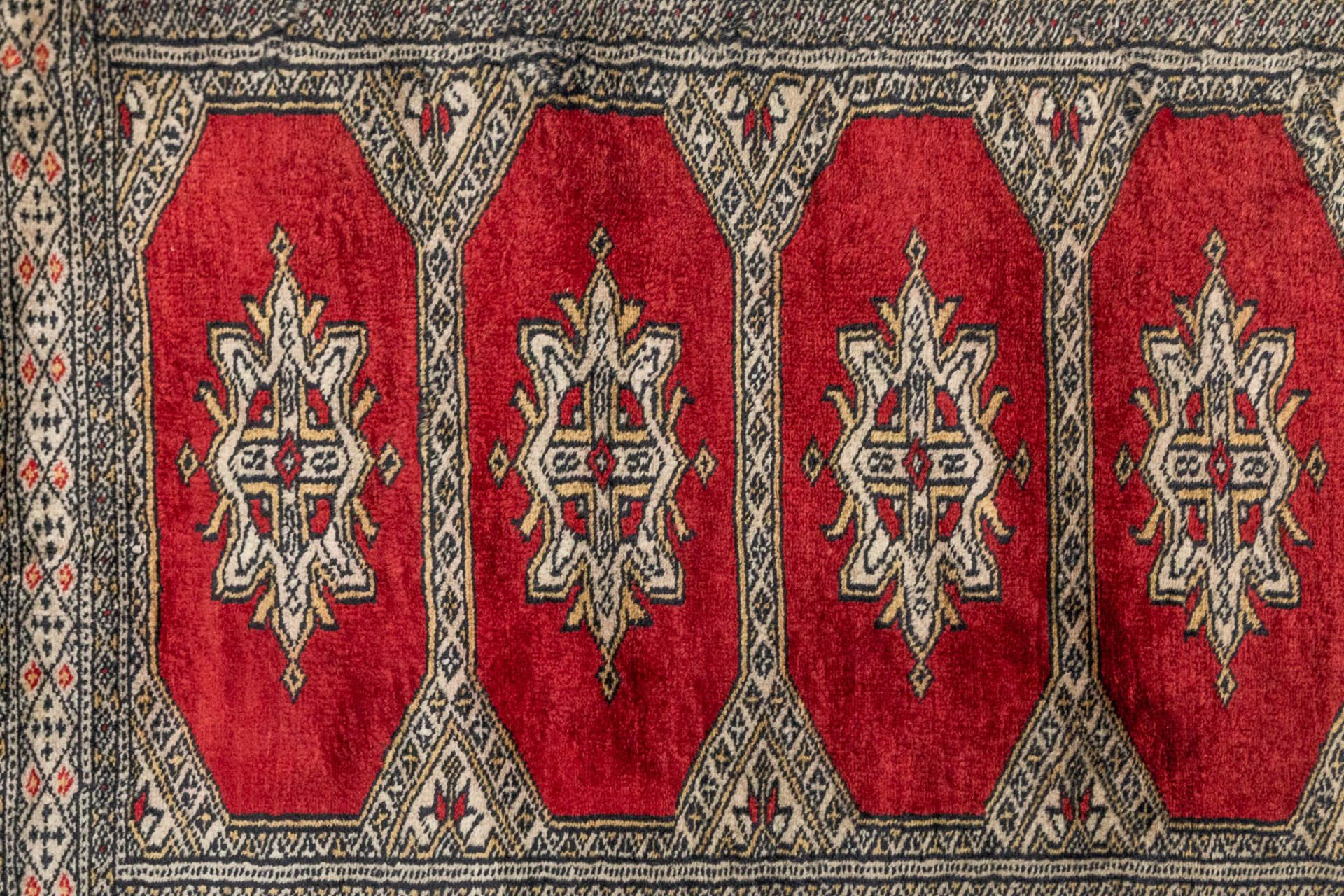 An Oriental hand-made runner carpet Bokhara (285 x 79 cm). - Image 6 of 7