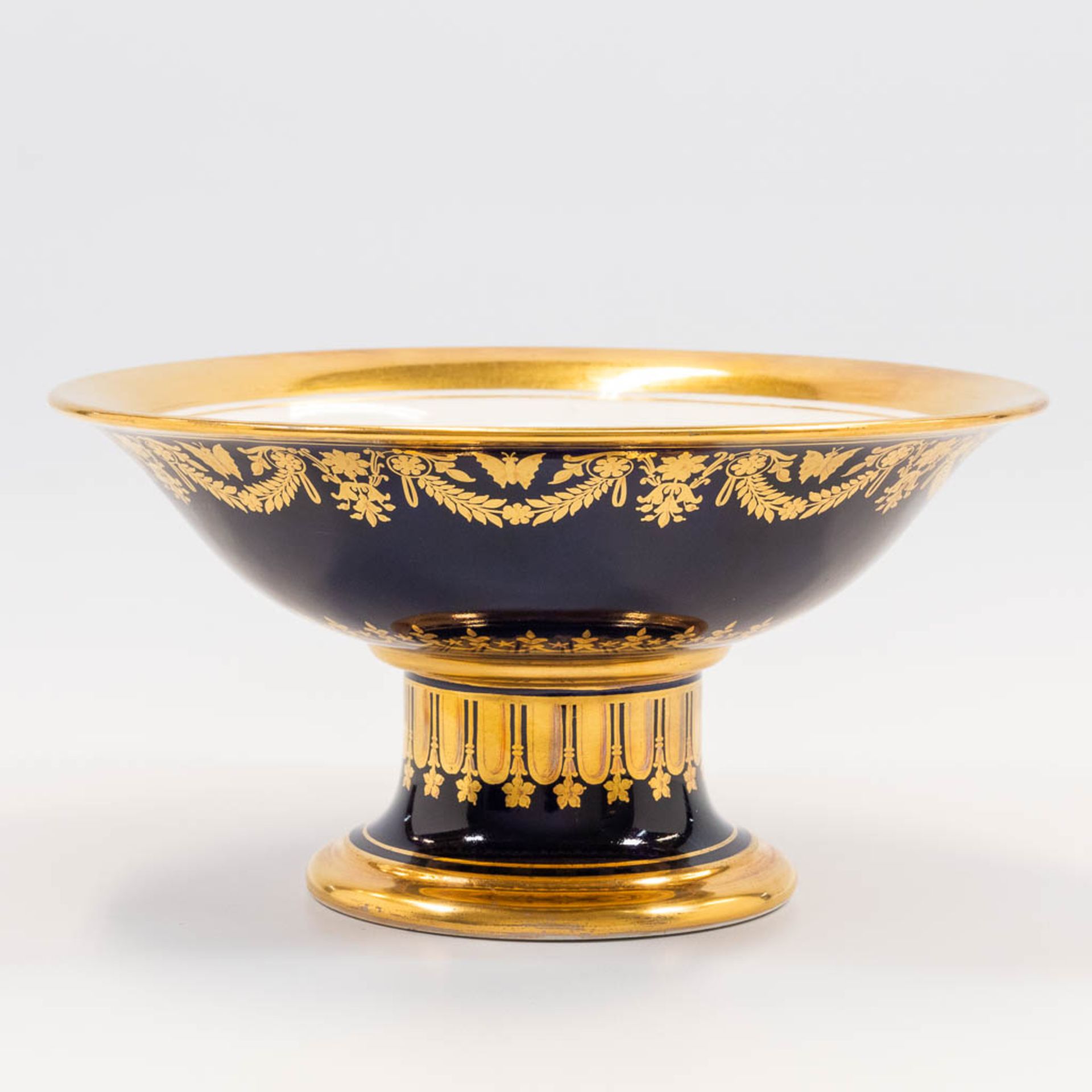 A tazza made in Limoges with cobalt blue and gold hand-painted decor. (11 x 21 cm)