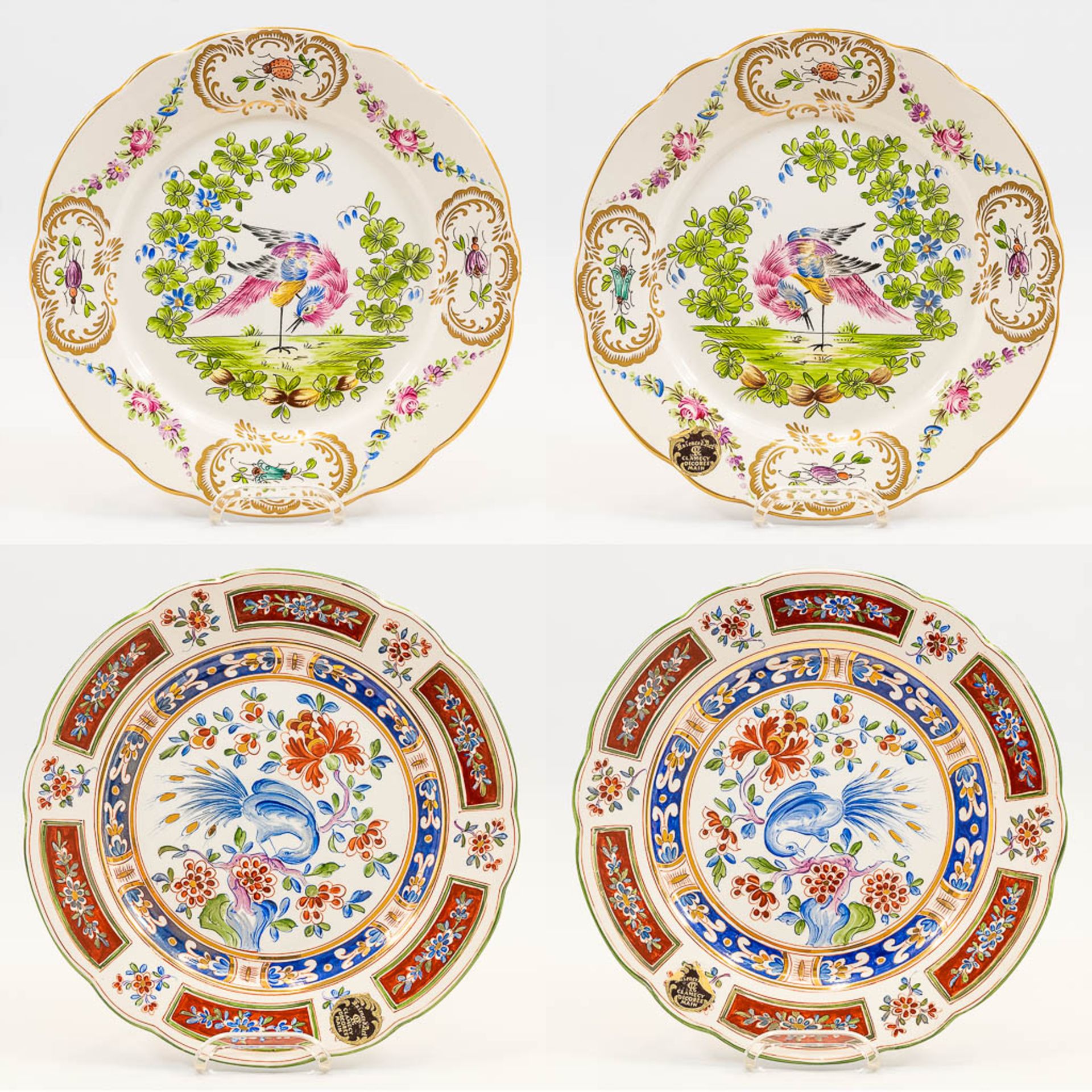 A collection of 2 pairs of faience display plates with hand-painted decor and made in Clamecy, Franc