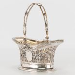 A siver basket, decorated with flowers an ribbons, with a crystal inside. Marked 800 with a half moo