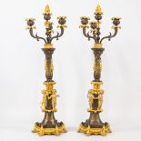 A pair of candelabra decorated with putti, combination of patinated and gilt bronze. 19th century. (