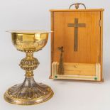 A silver neogothic chalice with paten in a wood box. Engraved images of the last supper. 19th centur