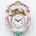A 'Jockele' clock made of porcelain with putti and handpainted decor, Germany, 19th century. (10 x 2