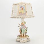 A porcelain table lamp with hand-painted decors and abat-ajour and marked Plaue, Germany. (28 x 28 x