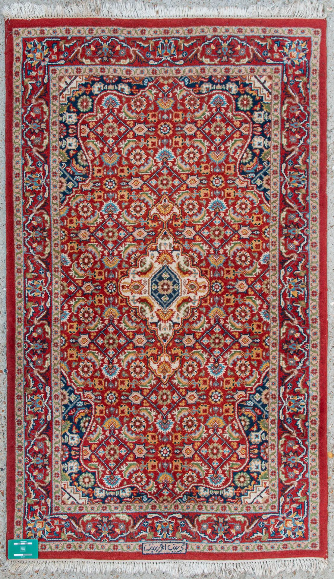 An Oriental hand-made carpet. Kerman with signature. (90 x 155 cm) - Image 6 of 6