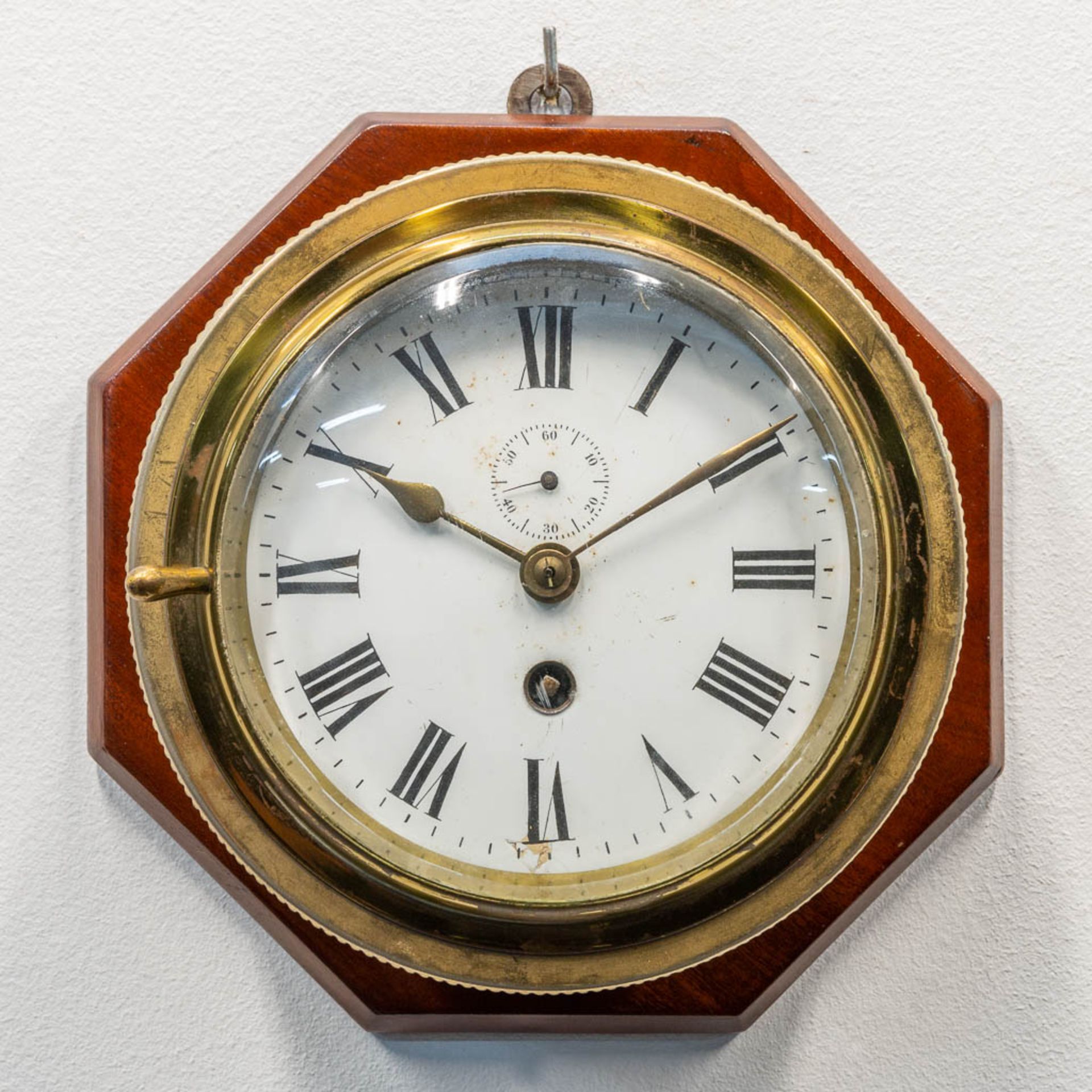 A ship clock mounted on wood, the first half of the 20th century. (9 x 20 cm)