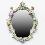 A mirror with putti made of porcelain in Plau, Germany during the second half of the 20th century. (