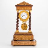 A column clock standing on a wood base and finished with marquetry inlay and gilt bronze. 19th centu