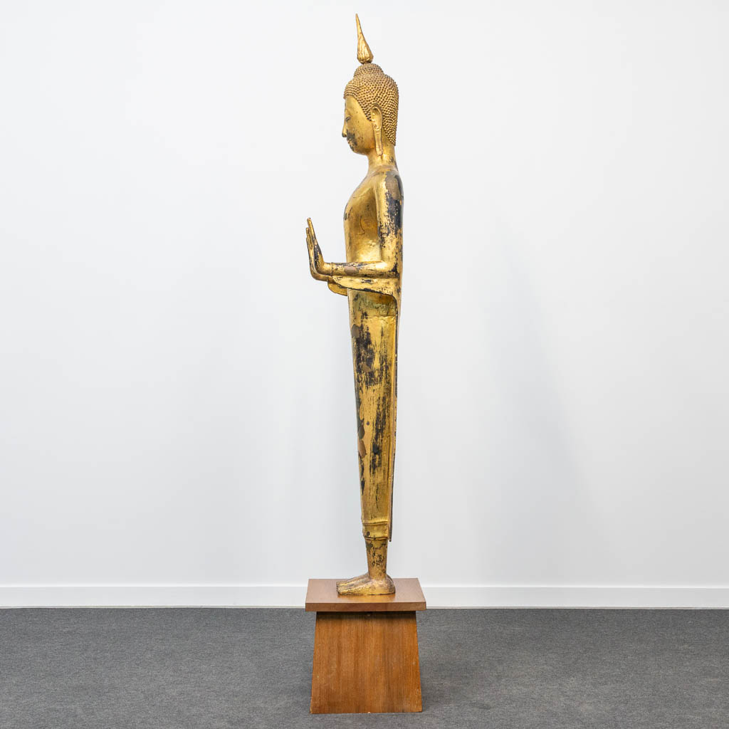 An antique buddha made of bronze and standing on a wood base. (28 x 48 x 180 cm) - Image 3 of 21