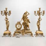 A 3 piece garniture clockset made of bronze with female figurines, consisting of a clock and 2 cande