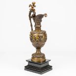 A large pitcher decorated with putti, standing on a black marble base. 19th century. (16 x 23 x 68 c