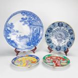 An antique Delft faience plate 'Peacock' marked Van Der Klaauw. Added 3 decorative Oriental plates.