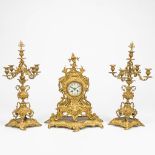 A 3 piece garniture clock mad e of bronze. The first half of the 20th century. (22 x 42,5 x 50 cm)