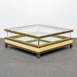 A mid-century coffee table made by Maison Jansen with a slide glass top. Made of glass and brass. (1