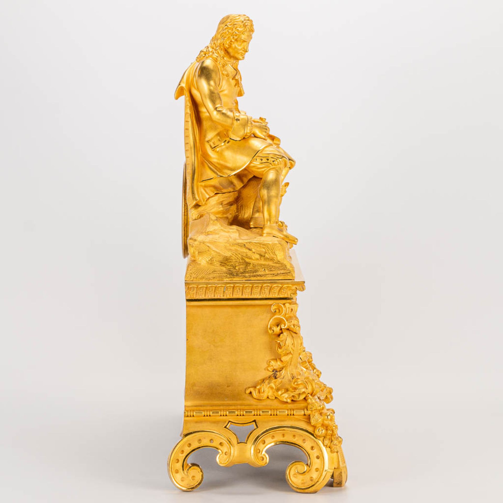 A table clock made of ormolu bronze with a sitting figurine. The second half of the 19th century. (1 - Image 2 of 24