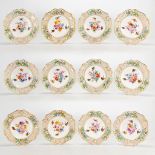 A large collection of 12 Meissen porcelain plates with hand-painted flower and bird decor with ajour