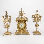 A three piece garniture clock made of bronze. The first half of the 20th century. (17,5 x 30 x 49 cm