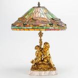 A table lamp with bronze figurines and a stained glass Tiffany style lamp shade with dragonflies. (5