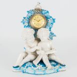 A pocket watch stand made of porcelain with hand painted decor and putti, Germany 19th century. (11