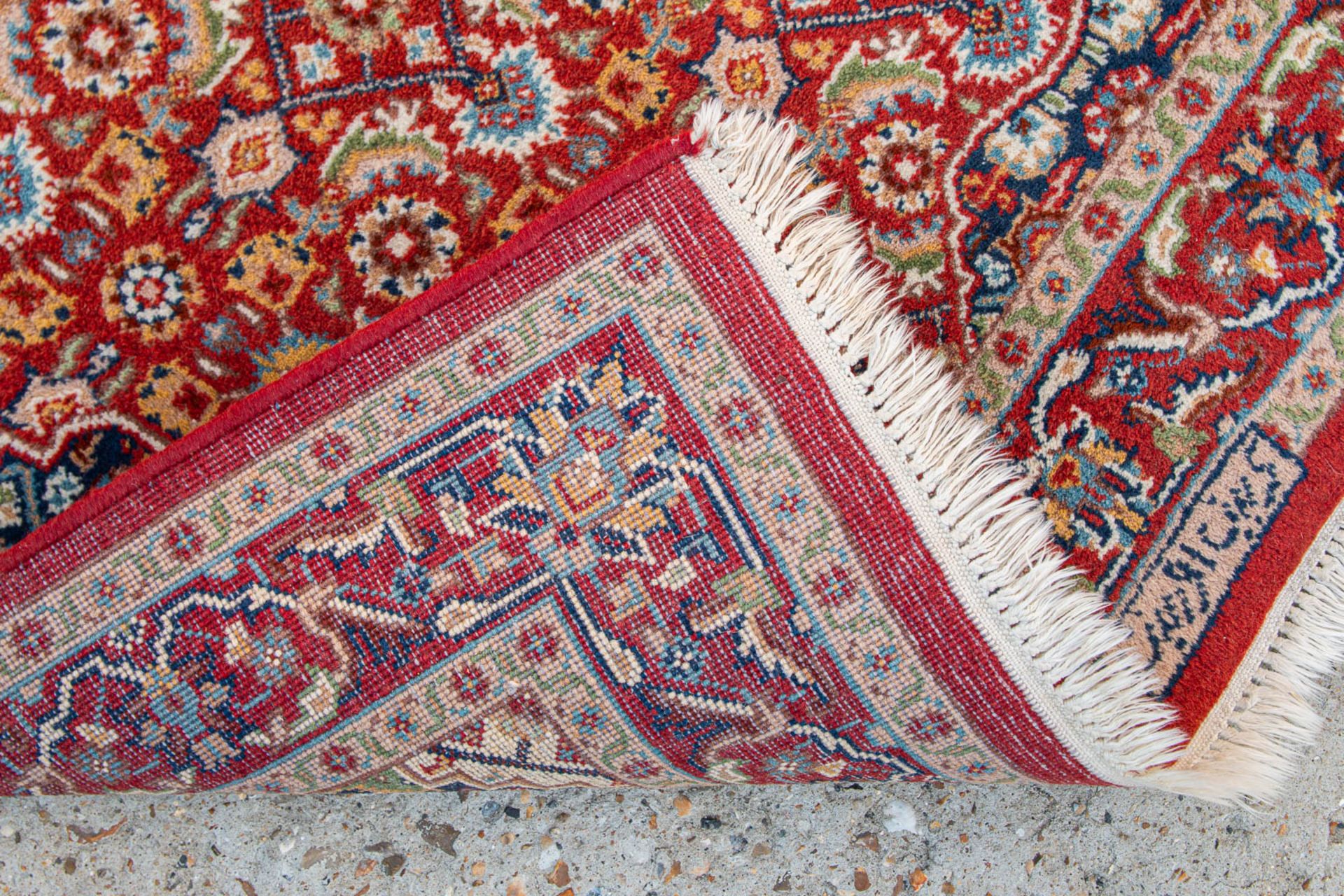 An Oriental hand-made carpet. Kerman with signature. (90 x 155 cm) - Image 3 of 6