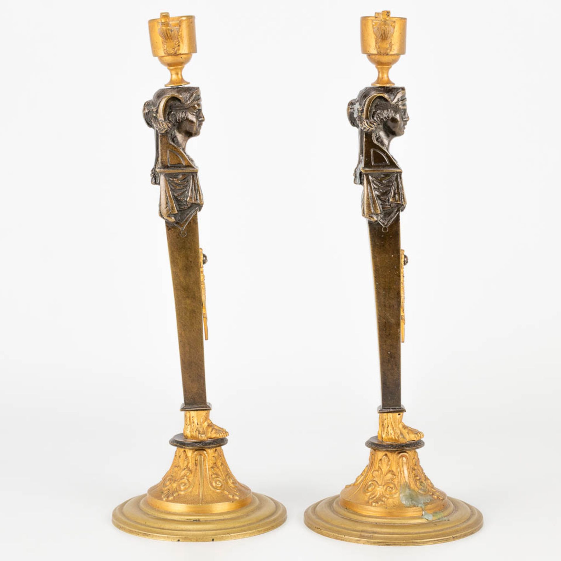 A pair of candlesticks made of gilt and patinated bronze in empire style. (27,5 x 9,5 cm) - Image 3 of 15