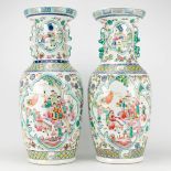 A pair of Chinese vases with decor of wise men, farmers, playing children and ladies. 20th century a