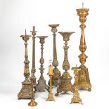 An assembled collection of 9 bronze and copper Church candlesticks. The first half of the 20th centu