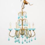 A mid-century chandelier made of opaline blue glass mounted on a brass frame. (66 x 52 cm)