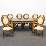 An exceptional dining room table, mounted with bronze and 8 chairs. Spain, the second half of the 20