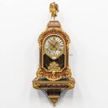 A cartel clock, finished with tortoise shell in a boulle technique, and mounted with gilt bronze. 19