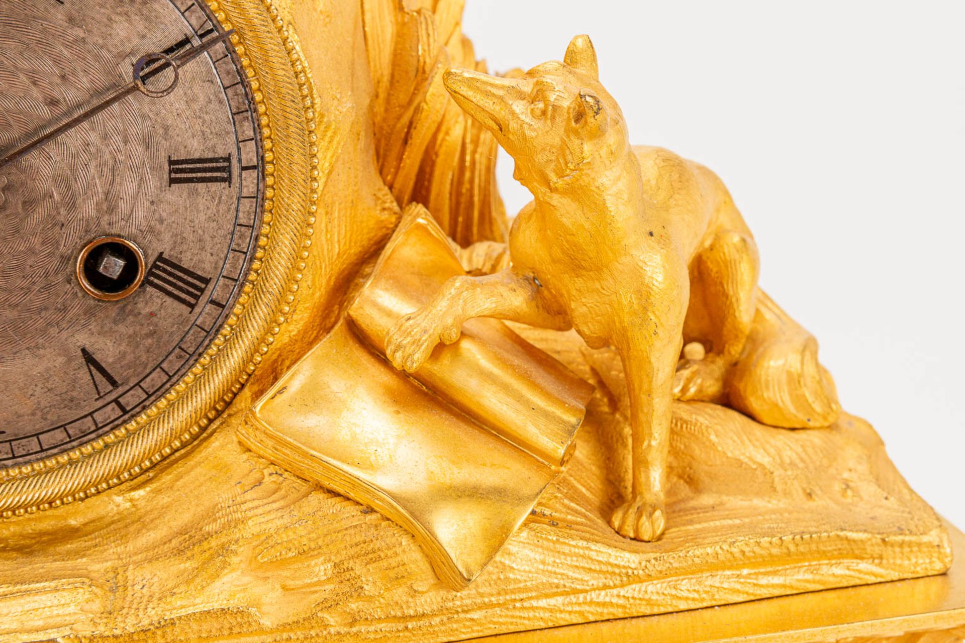 A table clock made of ormolu bronze with a sitting figurine. The second half of the 19th century. (1 - Image 19 of 24