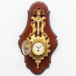 A bronze clock with thermometer, mounted on a wood base. 19th century. (19 x 7 x 34 cm)