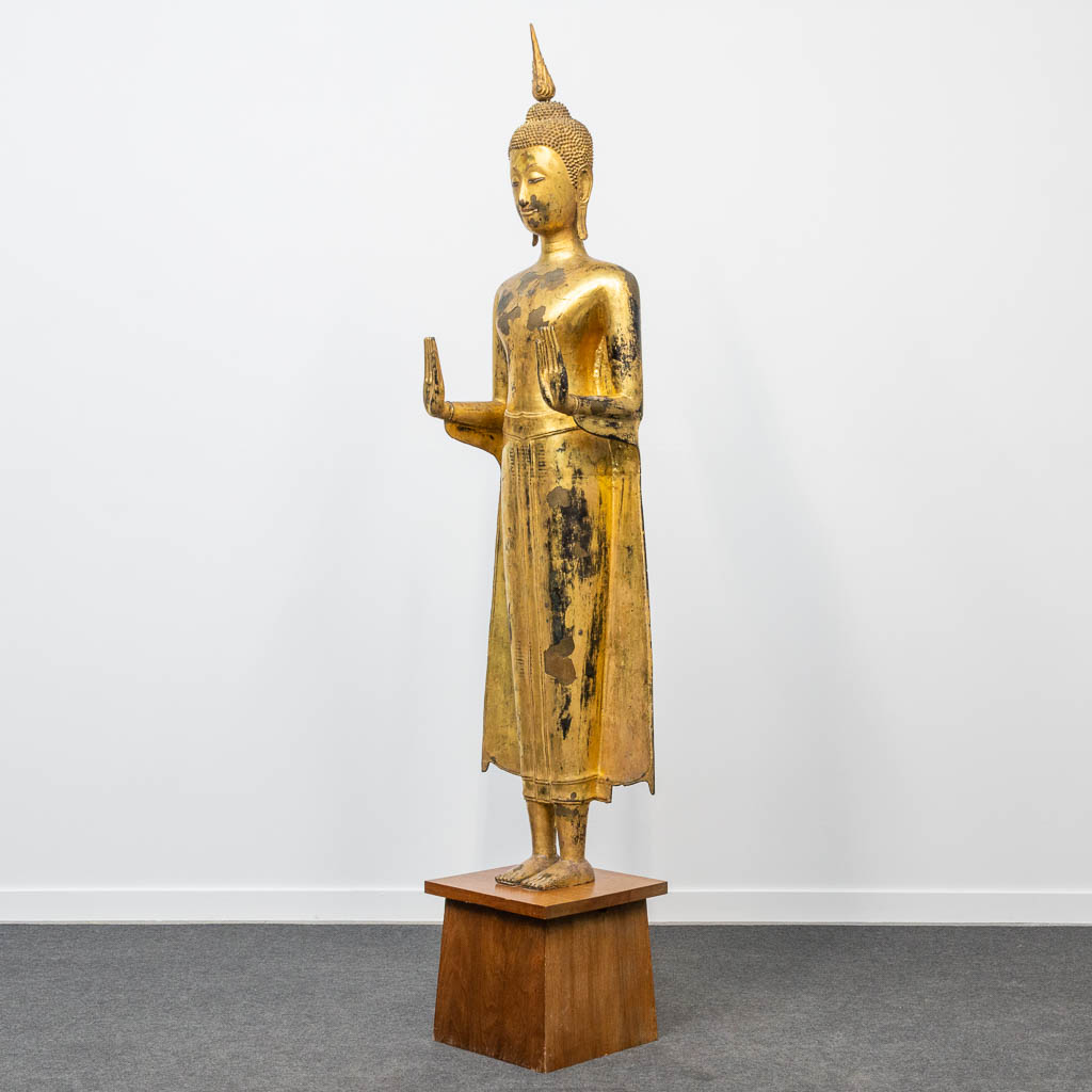 An antique buddha made of bronze and standing on a wood base. (28 x 48 x 180 cm) - Image 4 of 21