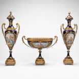 A pair of vases and a centerpiece made of porcelain mounted with bronze in Sevres style. The second