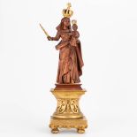 An antique wood sculptured statue of Madonna with child, standing on a gilt antique base. (12 x 16 x