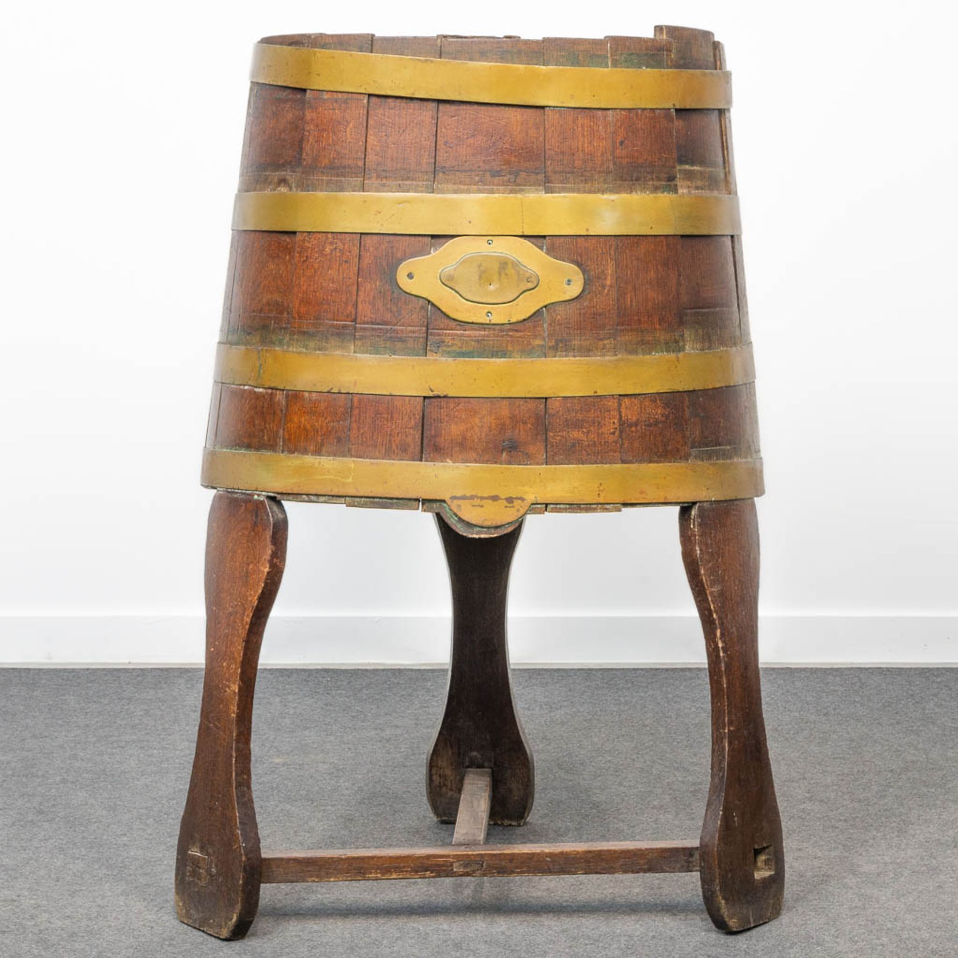 A churn standing on a base, made of oak and brass. (61 x 51 x 105 cm)