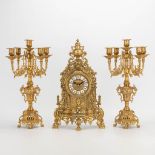 A 3 piece garniture clockset made of bronze, consisting of a clock and 2 candelabra. Battery operate