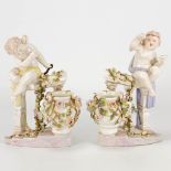 A pair of porcelain figurines of angels on a handrail with flowers, marked Sitzendorf porcelain and