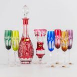 An assembled collection of cut crystal colored glasses WMF, a decanter and an Val Saint Lambert vase